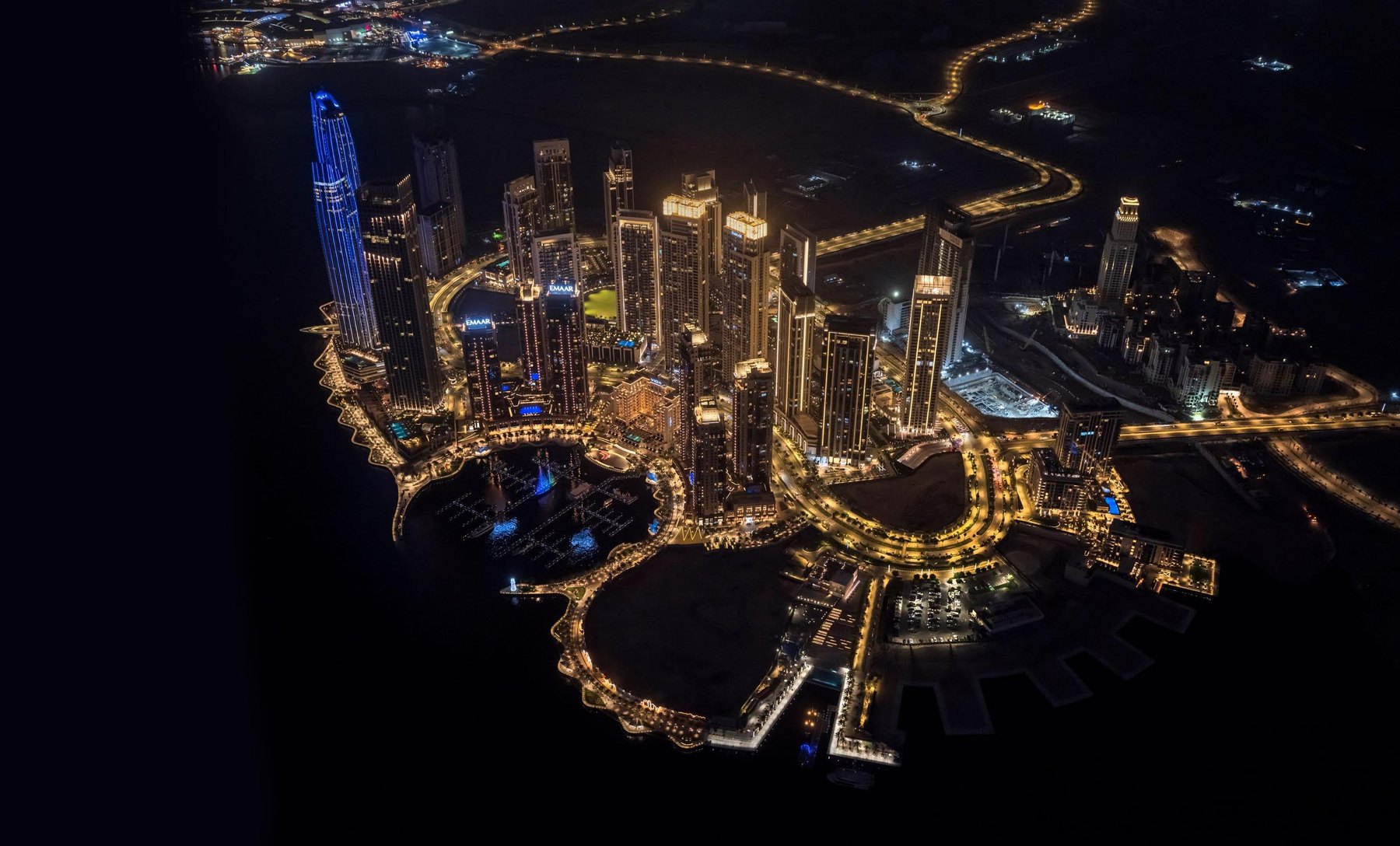 Aerial night view of Dubai Creek Harbour with the Dubai skyline beyond
